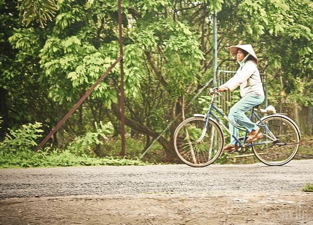 Vietnamese countryside lady on a bicycle.